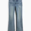 Jeans taille basse, coupe longue et ajustée, avec poches plaquées