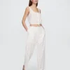 Pantalon ample à taille mi-haute et œillets